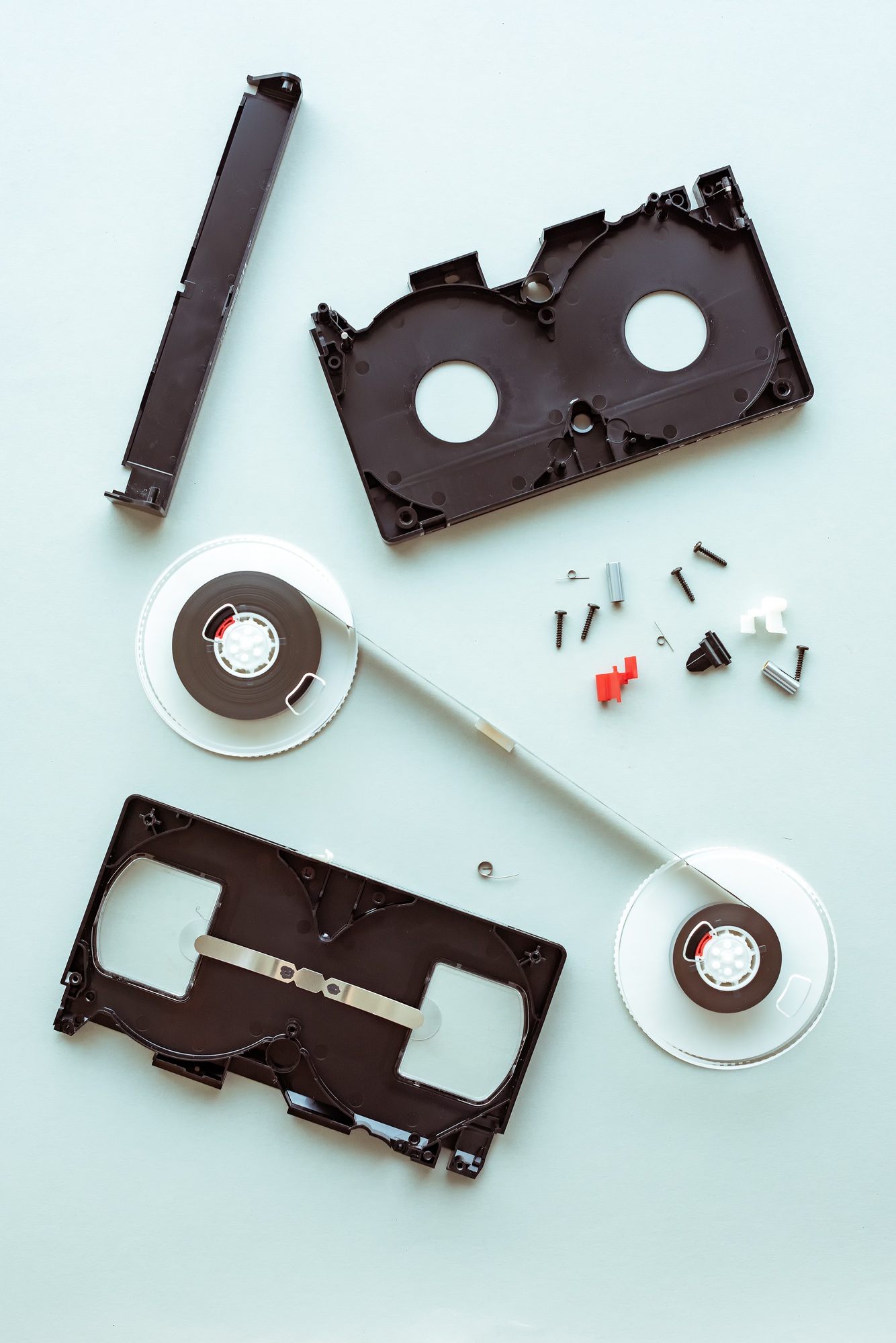 Flat lay vhs video cassette parts on pastel blue background